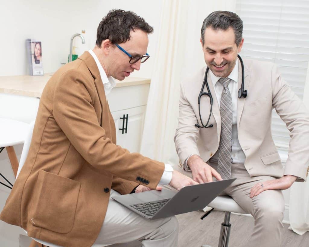2 Doctors at Family Tree Primary Care consulting on a laptop over a patient diagnosis.