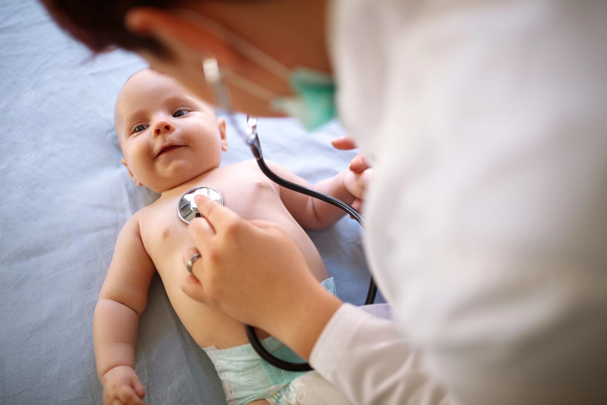 pediatrician listening to baby's heart