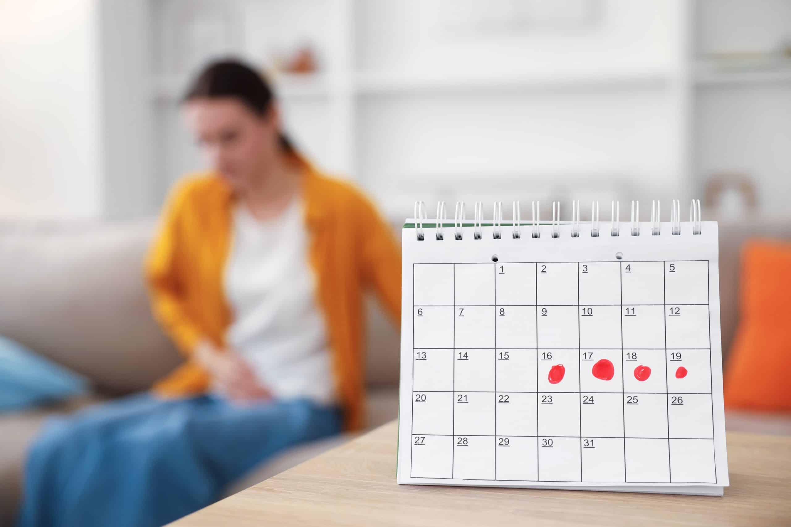 calendar with blurry woman in background