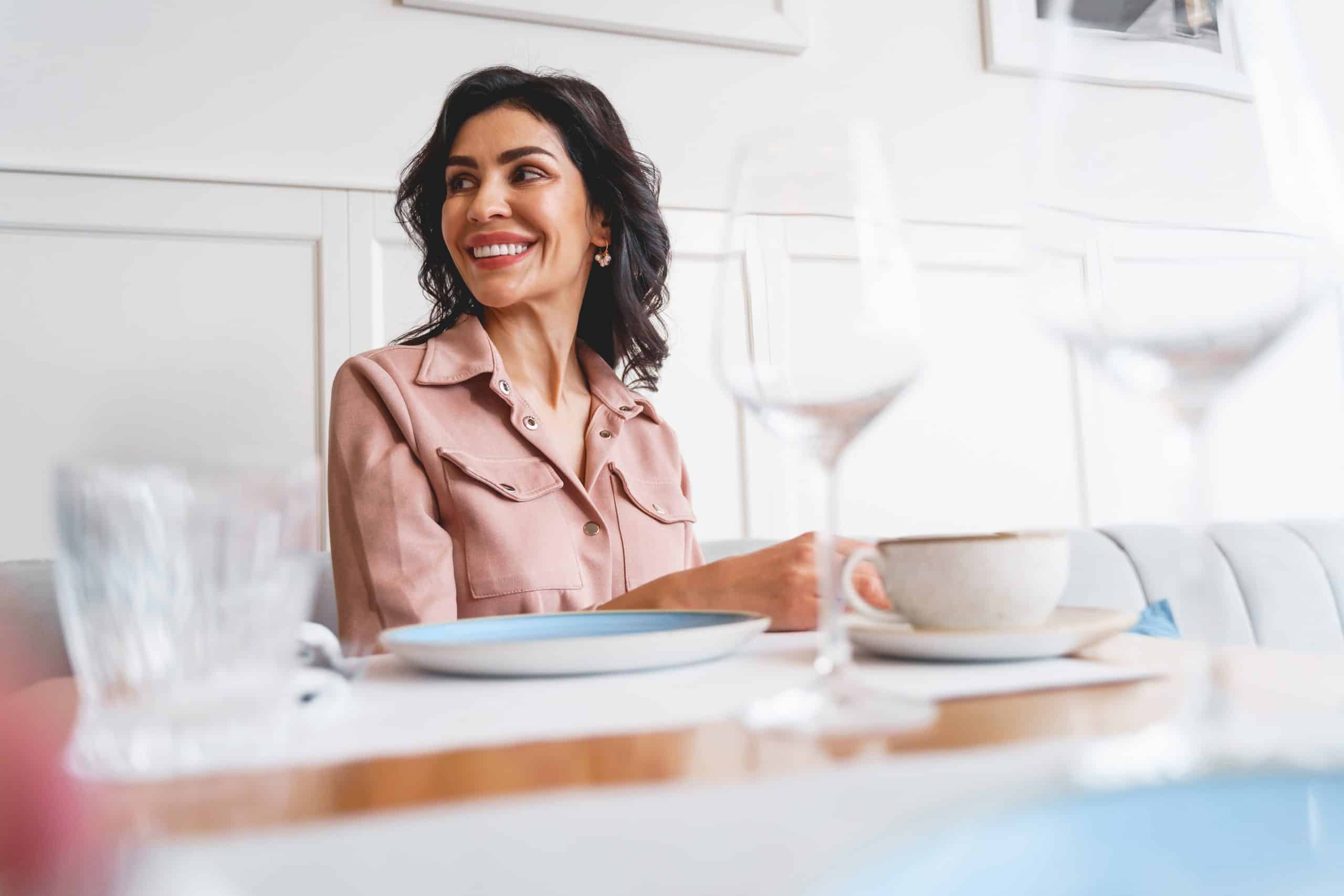 smiling woman sitting at restaurant