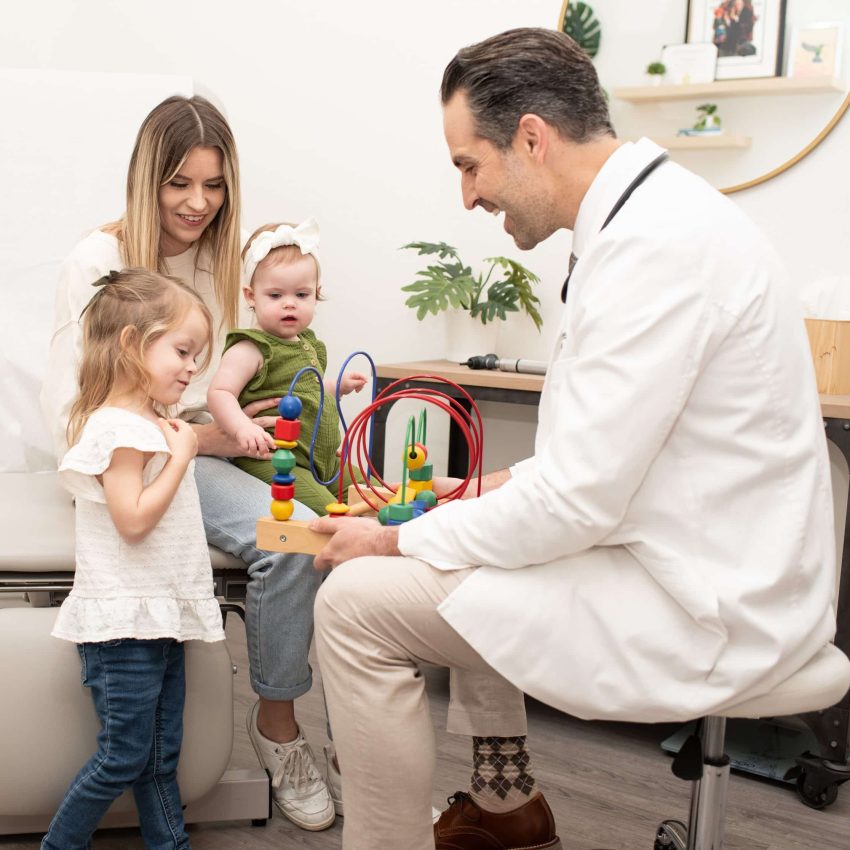 Doctor playing with toys with young patients before their exam
